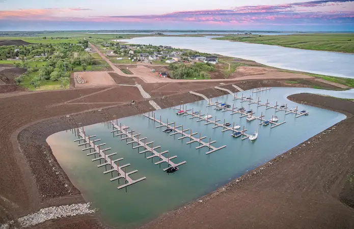 Sandy Shores marina at sunset with boat slips