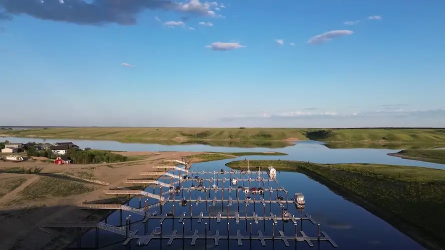 Boats on Lake Diefenbaker at sunset near Sandy Shores Resort & Marina